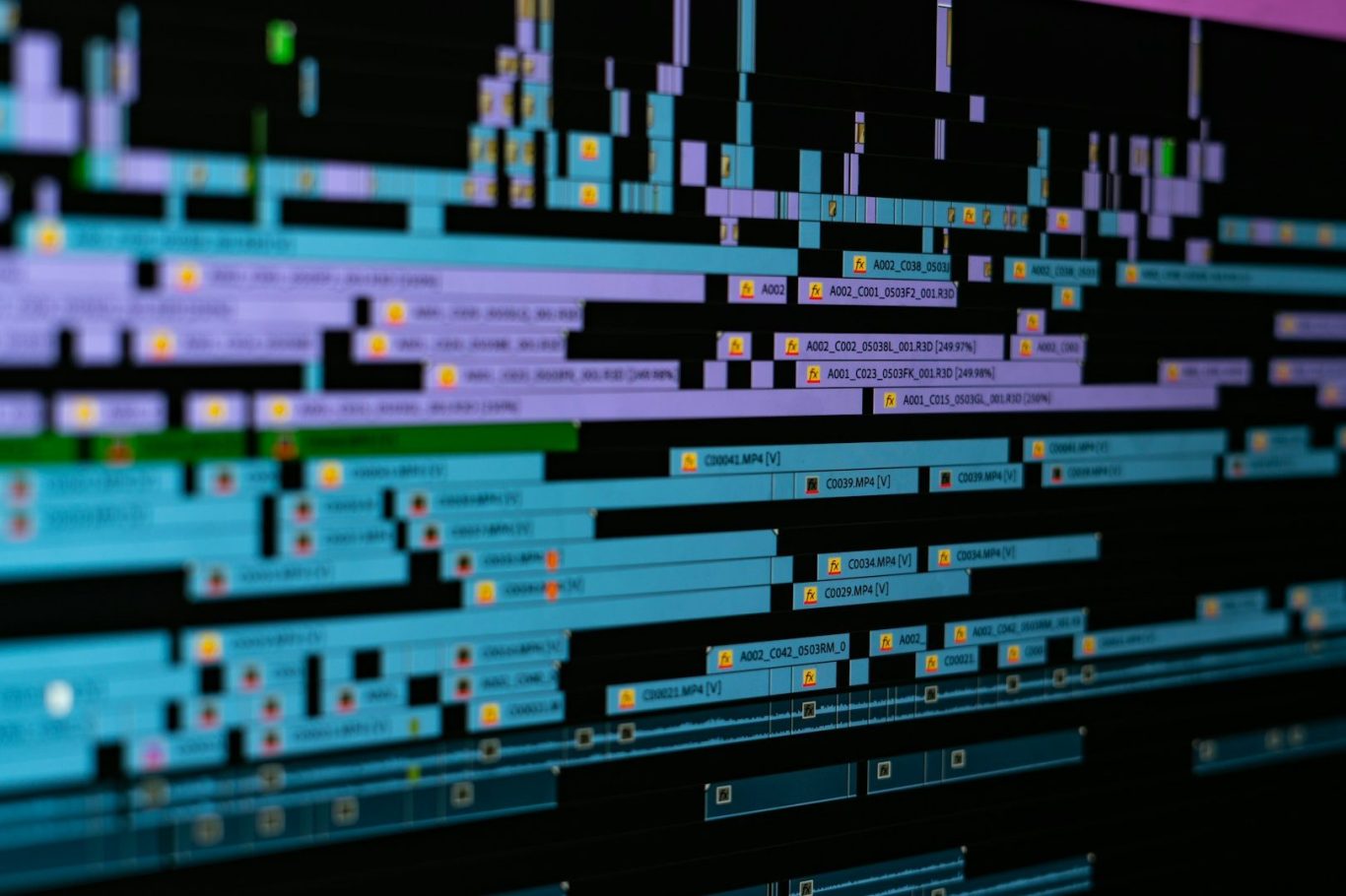 Post-Produzione Video Colorful digital timeline with various data tracks and markers displayed on a dark background.