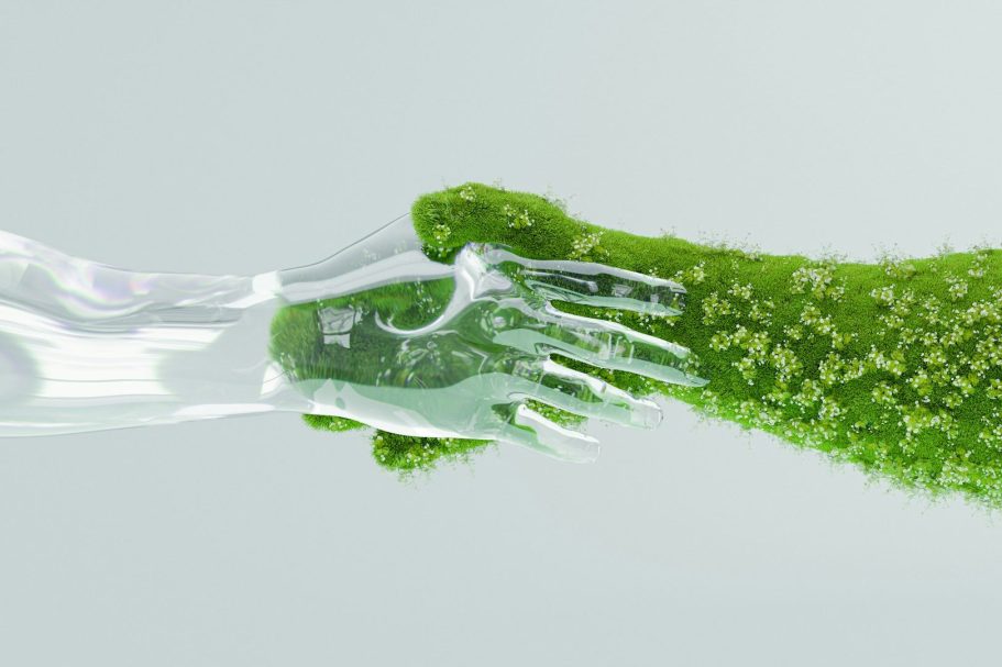 A glass hand and a green, textured hand reaching towards each other.